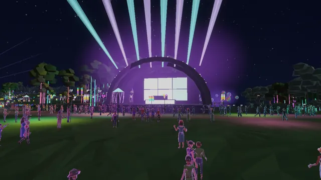 A dome stage throwing light beams into the night sky over a crowd