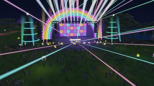 A packed crowd under a rainbow LED arch stage with lasers at night